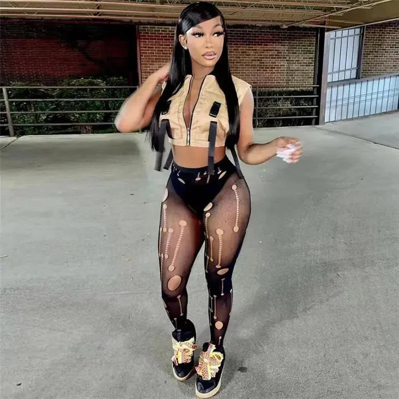 Woman in sleeveless beige crop top and skeleton print leggings posing in urban parking garage